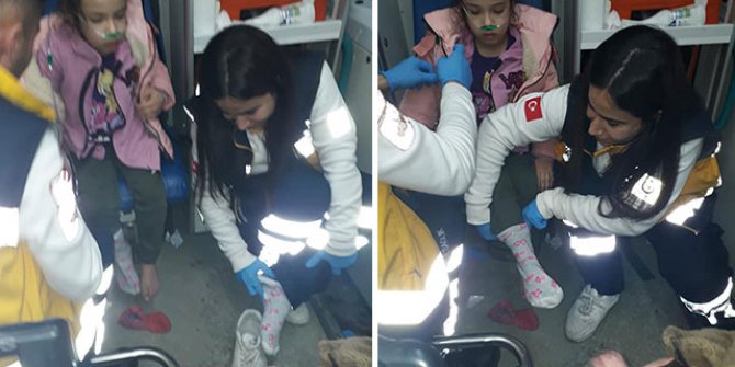 Sağlık çalışanı, yalın ayaklı çocuğa kendi çorabını giydirdi