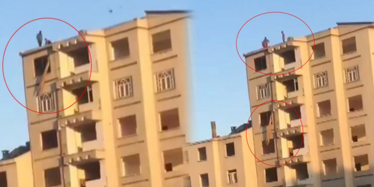 Ağır hasarlı binanın camından iple eşya indirdiler